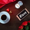 Romantic background with wedding ring, rose flowers, smartphone, cup of coffee and chocolate candy Royalty Free Stock Photo