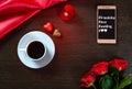 Romantic background with wedding ring, rose flowers, smartphone, cup of coffee and chocolate candy