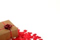 Romantic banner template with bunch of red silk hearts and gift box, covered by brown craft paper, tied by red mettalic bow and