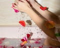 Romantic bath with white water and rose petals