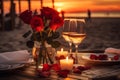 Romantic beachside dinner setup with sunset view, rose centerpieces, candles, and sparkling wine Royalty Free Stock Photo