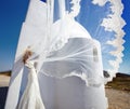 Romantic beautiful bride in white dress posing on terrace with sea and mountains in background in Santorini island, Greece Royalty Free Stock Photo