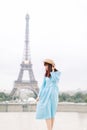 Romantic beautiful girl portrait with tour eiffel on the background. Pretty tender young lady in blue dress and hat Royalty Free Stock Photo