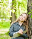 Romantic beautiful girl writes love poems on nature Royalty Free Stock Photo