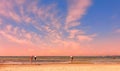 Romantic beautiful sunset afternoon at sea people silhouette on horizon Baltic Sea seashell on the rock sea sky
