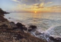 Romantic beautiful sunset, sunrise. Picturesque sea landscape with a rocky shore Royalty Free Stock Photo