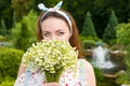 Romantic beautiful young woman smelling flowers outside Royalty Free Stock Photo