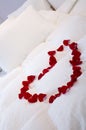Romantic bed with heart of roses Royalty Free Stock Photo