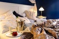 Romantic bedroom rumpled covers hotel champagne bucket