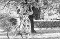 Romantic bike ride. Girl long dress retro cruiser bicycle sakura tree. Spring holidays. Tourism concept. Transportation