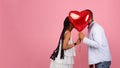 Romantic Black Couple Kissing Hiding Behind Red Heart Balloon Royalty Free Stock Photo