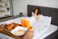 Romantic black guy bringing breakfast in bed for his excited girlfriend, blank space Royalty Free Stock Photo