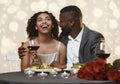 Romantic black man courting his pretty girlfriend in restaurant