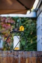 Romantic black metal lantern lamp with candle. Backyard, cozy decor outdoor