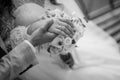 Romantic Black and White Wedding Moment with Intertwined Hands and Bouquet Royalty Free Stock Photo