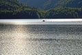 Lonely romantic boat tour in idyllic lake landscape by dusk Royalty Free Stock Photo