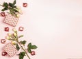 Romantic border of rose flowers, gift boxes and decorative hearts on pink background. Place for text, top down composition Royalty Free Stock Photo