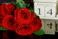 Romantic bouquet of beautiful red roses with calendar date February 14th