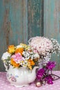 Romantic bouquet of flowers in vintage kettle