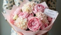 A romantic bouquet of pastel-colored peonies and hydrangeas wrapped in soft pink tissue paper, with a handwritten note attached Royalty Free Stock Photo