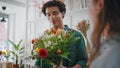 Romantic boyfriend shop flowers bouquet in shopping mall floristry store. Royalty Free Stock Photo