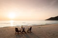 Romantic breakfast on beach. Breakfast table with island sunrise Royalty Free Stock Photo