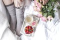 Romantic breakfast in bed. A bouquet of roses and a fragrant morning coffee. Fresh strawberries. Good morning, in the crumpled bed Royalty Free Stock Photo