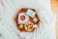 Romantic Breakfast in bed with I love you baby text on lighted box. Cup of coffee, juice, macaroons, flower and gift box on wooden Royalty Free Stock Photo