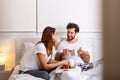 Romantic breakfast in bed man prepare for his woman, she was very happy, Young beautiful couple in bed having a breakfast and Royalty Free Stock Photo