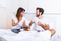 Romantic breakfast in bed man prepare for his woman, she was very happy, Young beautiful couple in bed having a breakfast and Royalty Free Stock Photo