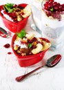 Romantic breakfast with chia, granola, yogurt and berries on old white concrete background. Health and diet concept. Royalty Free Stock Photo