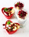 Romantic breakfast with chia, granola, yogurt and berries on old white concrete background. Health and diet concept. Royalty Free Stock Photo