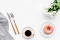 Romantic breakfast with flowers on the table. Coffee with dessert on white background top view copy space