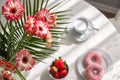 Romantic breakfast in the kitchen with a bouquet of flowers, donuts, coffee and fresh strawberries. Brunch on a sunny day. View Royalty Free Stock Photo
