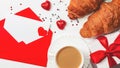 A romantic breakfast for a loved one on Valentine`s Day. Fresh delicious croissants with a cup of coffee, chocolate hearts, paper Royalty Free Stock Photo