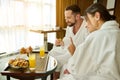 Romantic breakfast on weekend morning of attractive affectionate couple in love, enjoying intimate moments together in hotel room Royalty Free Stock Photo