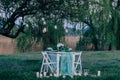 Romantic breakfast at the well-served table outdoors in the beautiful garden