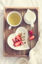 Romantic breakfast. Yogurt with granola and strawberry in bowl