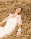 Romantic bride on haystack. Royalty Free Stock Photo