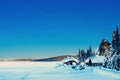 Romantic cabin by a frozen remote lake covered with snow