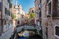 Romantic canal in Venice, Italy with scenic bridge.