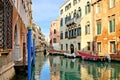 Canals with reflections, bridge and gondola, Venice, Italy Royalty Free Stock Photo