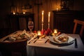 romantic candlelit dinner for two, with beautiful plates and silverware on the table Royalty Free Stock Photo