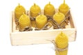 Romantic candles made of natural wax, in a wooden box, made for the holiday. The candle is made of honeycomb