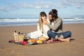 Romantic Caucasian couple enjoying picnic at seashore Royalty Free Stock Photo