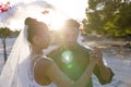 Romantic caucasian newlywed young couple dancing at beach at wedding ceremony during sunset Royalty Free Stock Photo