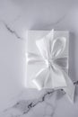 Luxury wedding gifts with silk bow and ribbons on marble background Royalty Free Stock Photo