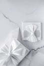 Luxury wedding gifts with silk bow and ribbons on marble background Royalty Free Stock Photo
