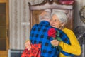 Romantic celebration concept. Elderly caucasian couple celebrating their anniversary. Retired man hugging his gray Royalty Free Stock Photo