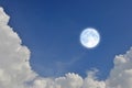 Romantic and charming full moon in blue sky with white clouds Royalty Free Stock Photo